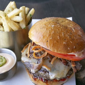 gourmet cheese and bacon burger with gherkin and fries